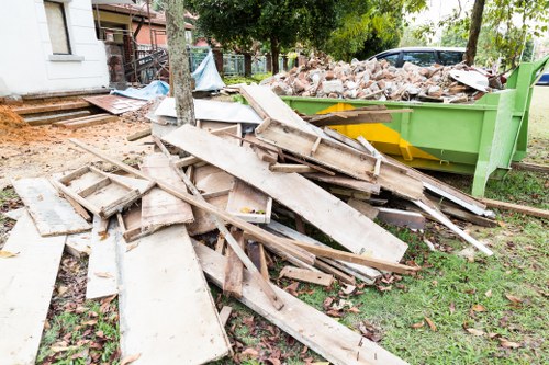Business professionals loading waste into a skip